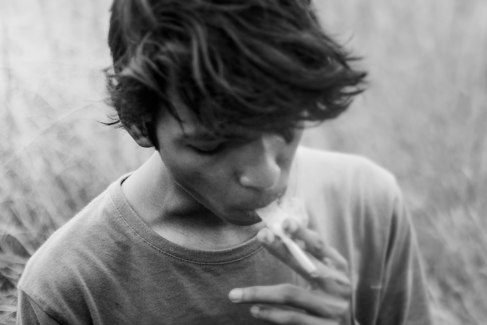 grayscale photography of man smoking