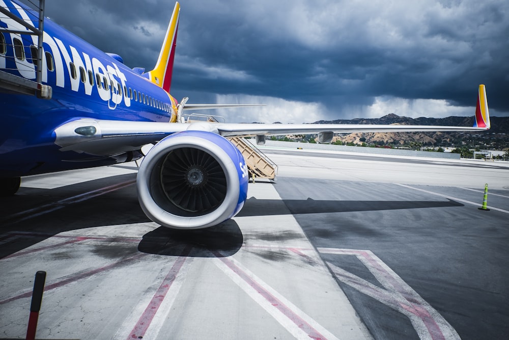 passenger plane on airport under gray cloudy sky