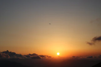 A cinematic camera setup with a drone hovering nearby during golden hour.