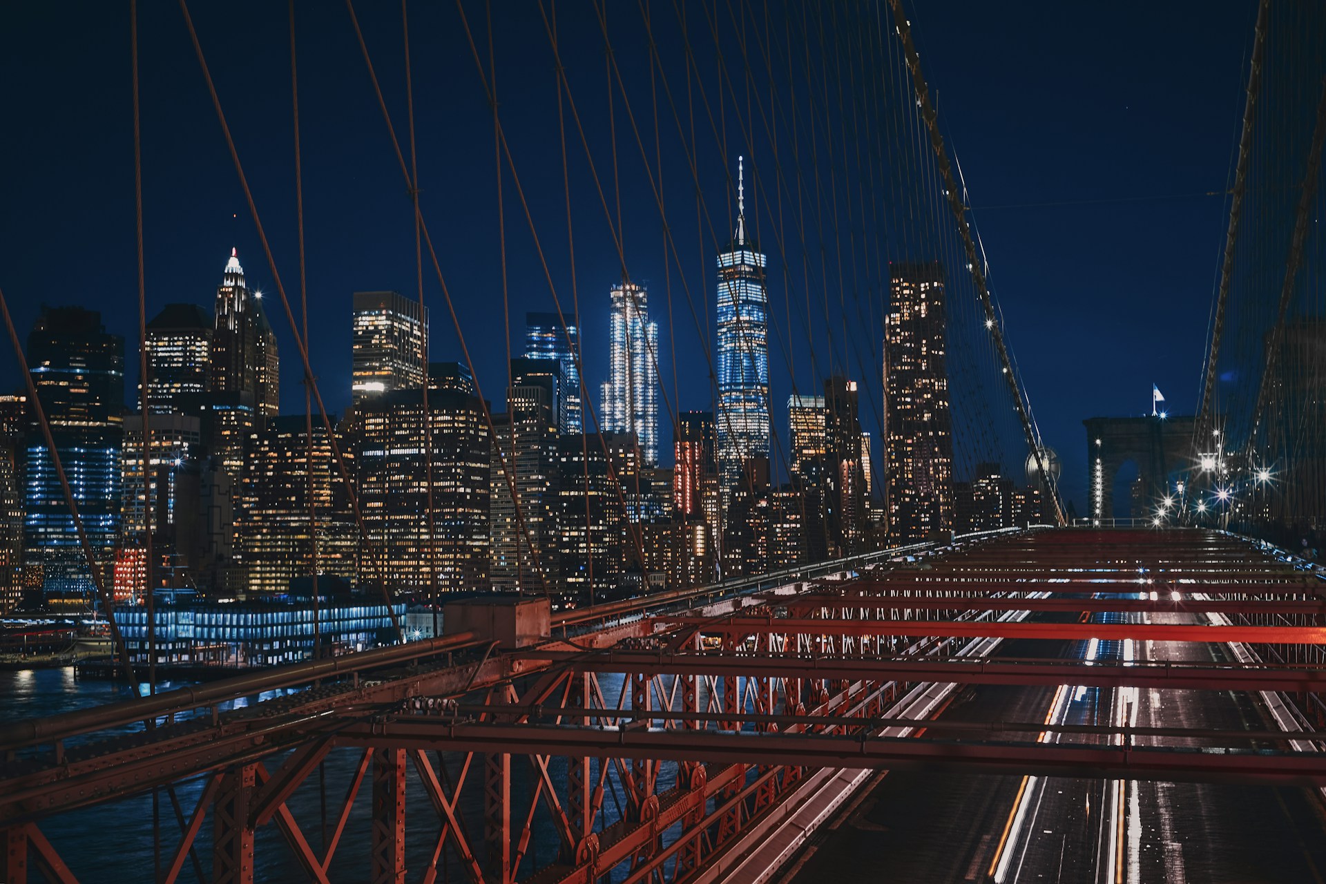 bridge near city buildings during nighttime