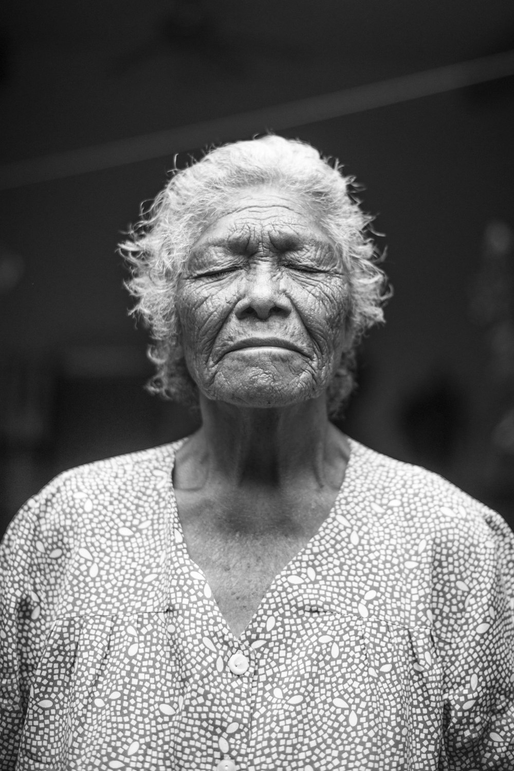 grayscale photo of closed-eyes woman