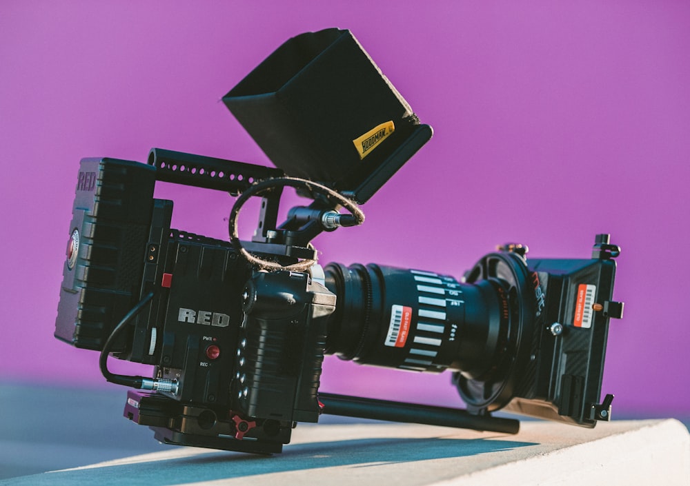 shallow focus photography of black professional video camera on table