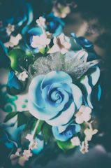 Close-up of sugar decorations shaped like flowers and leaves.