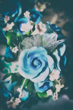 Close-up of sugar decorations shaped like flowers and leaves.