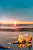 clear glass mason jar on beach during sunset