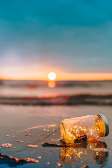 clear glass mason jar on beach during sunset