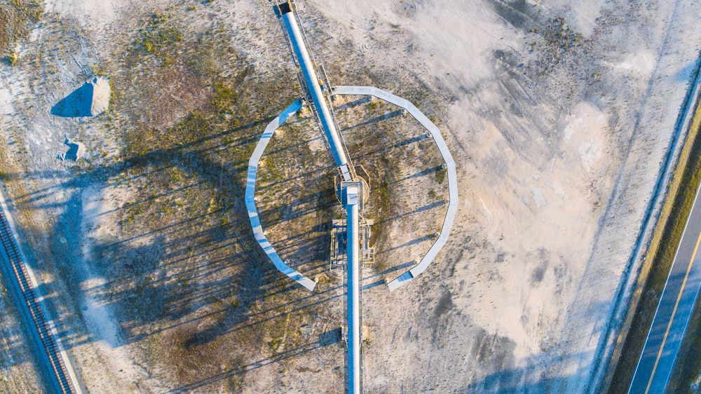 an aerial view of a train track in the middle of nowhere