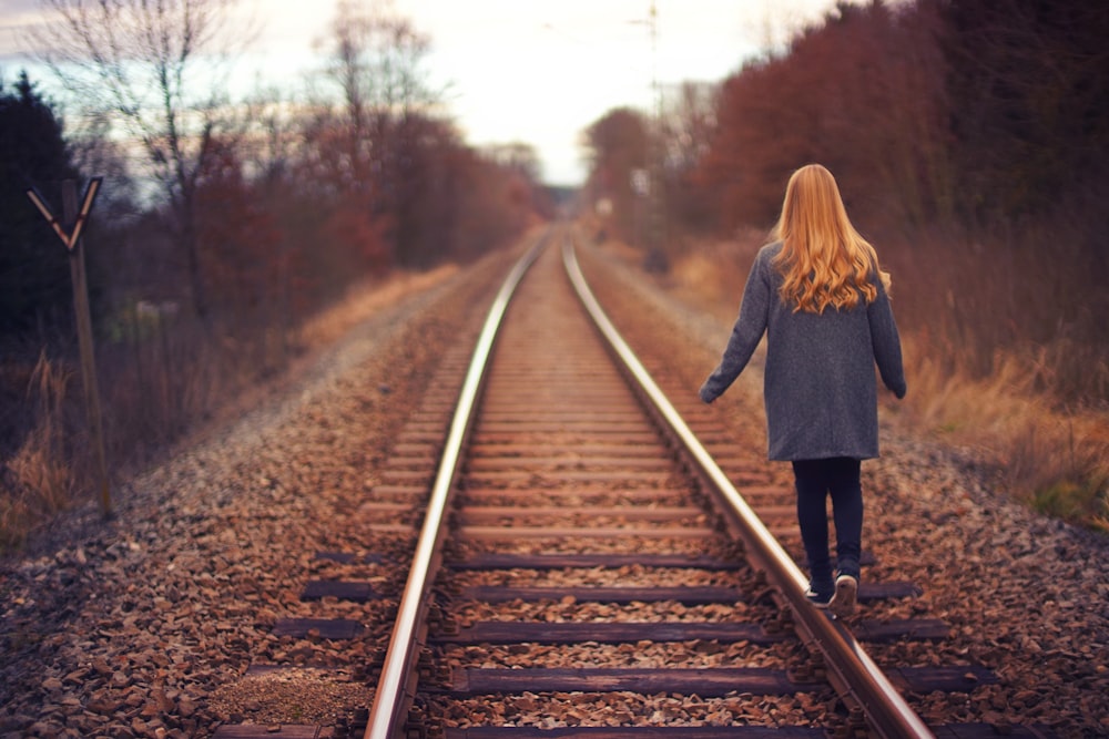 woman walking on rail road