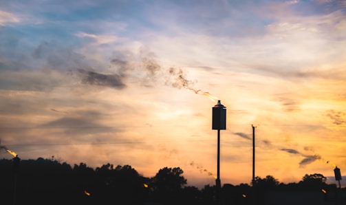 UV flame detector installed near an oil refinery unit during sunset