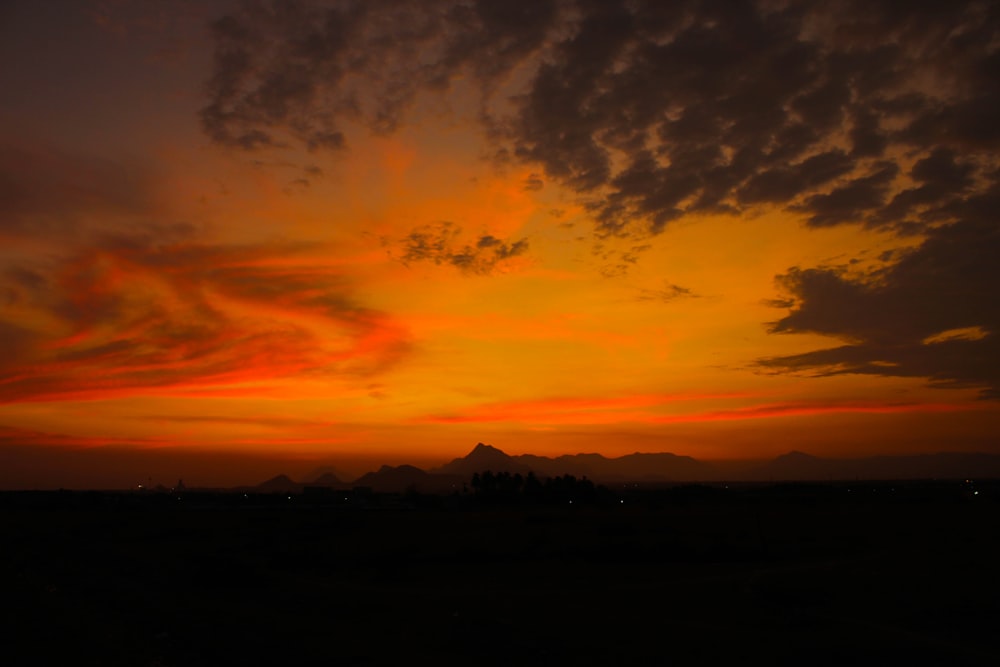 mountains under orange kies