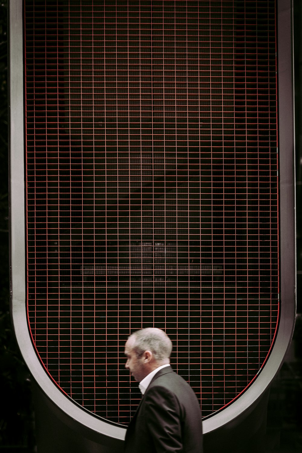 man walking white wearing black suit