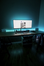 A sleek workspace with a laptop displaying a global hiring dashboard glowing in neon colors.