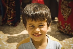 A warm image of Ayush Gawai smiling while presenting his work at a local event.