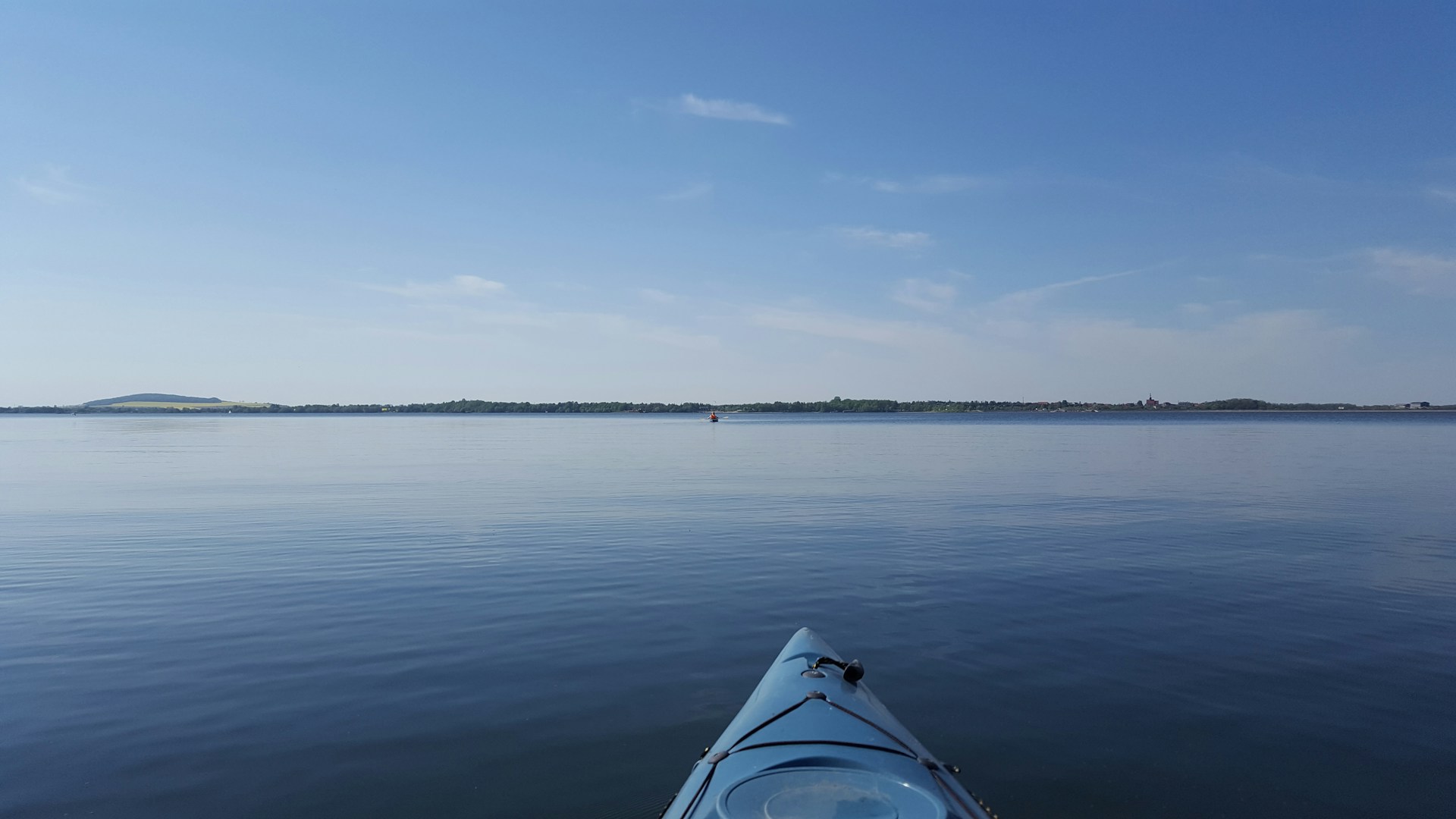 woman wearing yellow long-sleeved dress under white clouds and blue sky during daytime