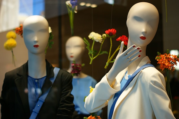 A modern outfit display on a mannequin with chic accessories in a black, white, and purple themed room.