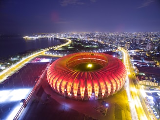 A beautiful view of the stadium lit up at night.