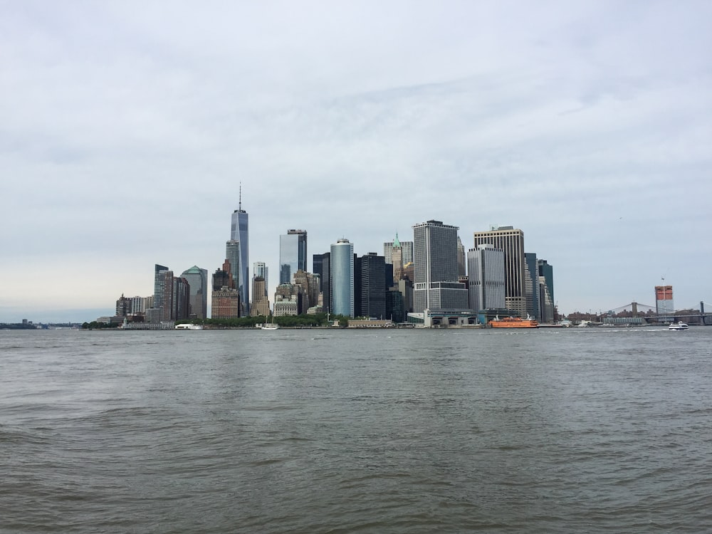 city skyline across body of water during daytime