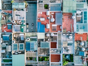 An aerial view of multiple rooftops equipped with solar panels.