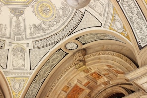 Skilled workers restoring a palace ceiling with intricate designs