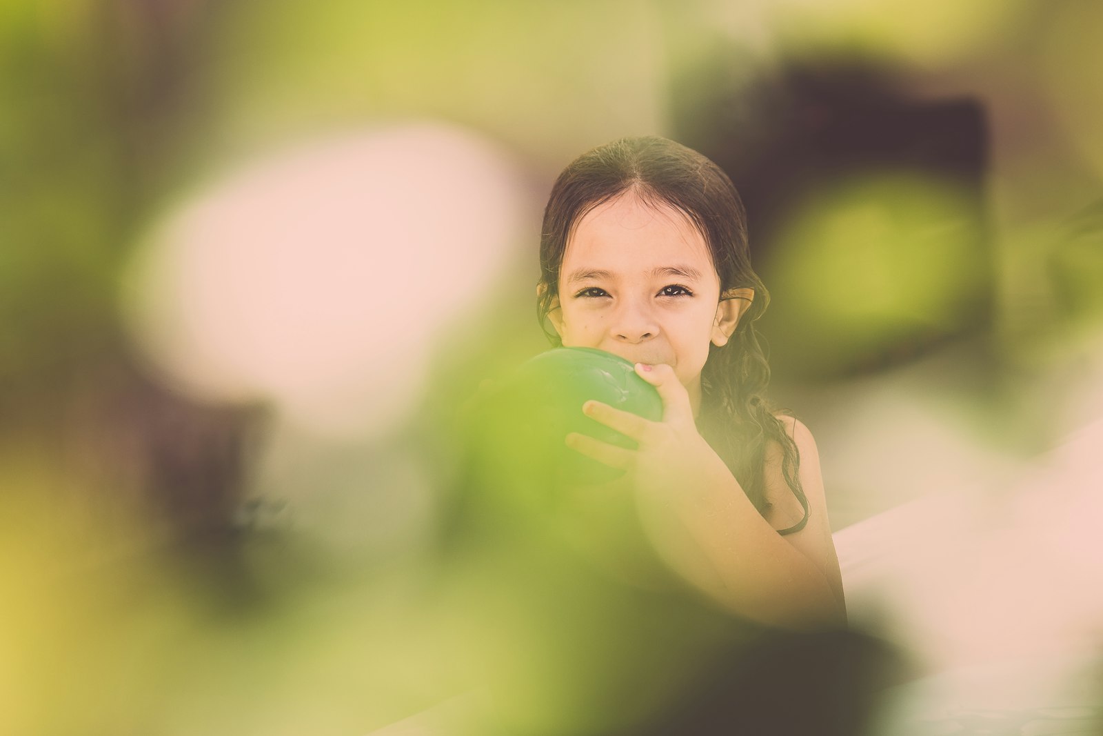 Canon EOS 6D + Sigma 24-70mm F2.8 EX DG Macro sample photo. Girl blowing green balloon photography