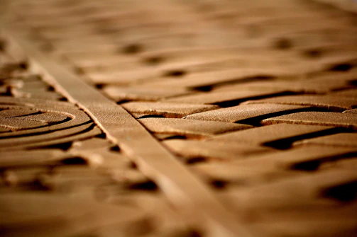 Close-up of delicate elven-inspired wood carvings glowing softly under moonlight.