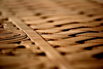 Close-up of intricate Masonic symbols carved in wood with soft lighting.