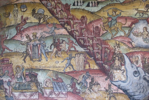 An intricate mural with detailed depictions of various human and mythological figures, including a crowned central figure accompanied by smaller figures that appear to represent demons. The setting includes symbolic representations and allegorical scenes with vivid imagery, capturing a sense of narrative and drama. Notable elements include a centaur, figures involved in activities, and elements that suggest a historical or religious context with a colorful, dynamic composition.