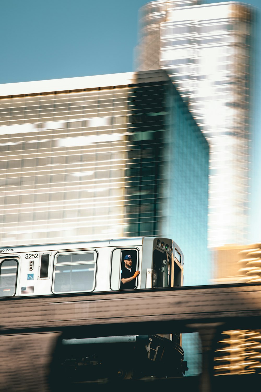 focus photography of person riding gray train