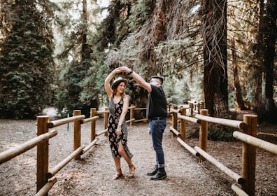 man and woman dancing between brown wooden handrails