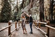 man and woman dancing between brown wooden handrails