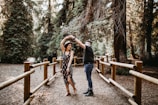 man and woman dancing between brown wooden handrails
