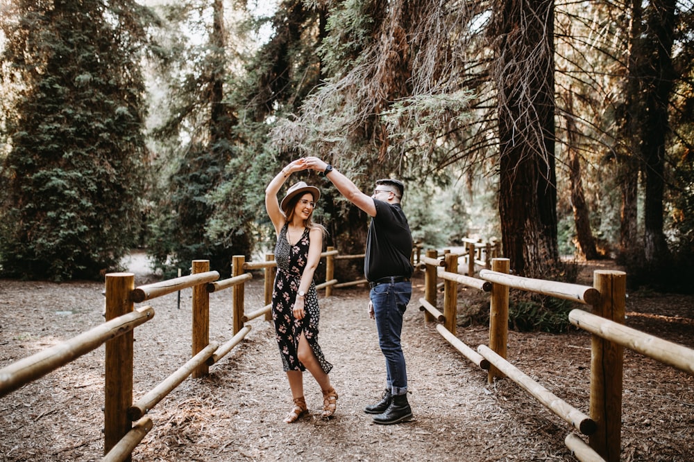 man and woman dancing between brown wooden handrails