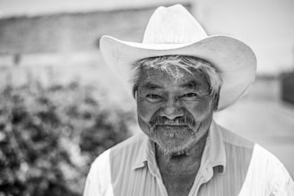 grayscale photo of man wearing cowboy hat