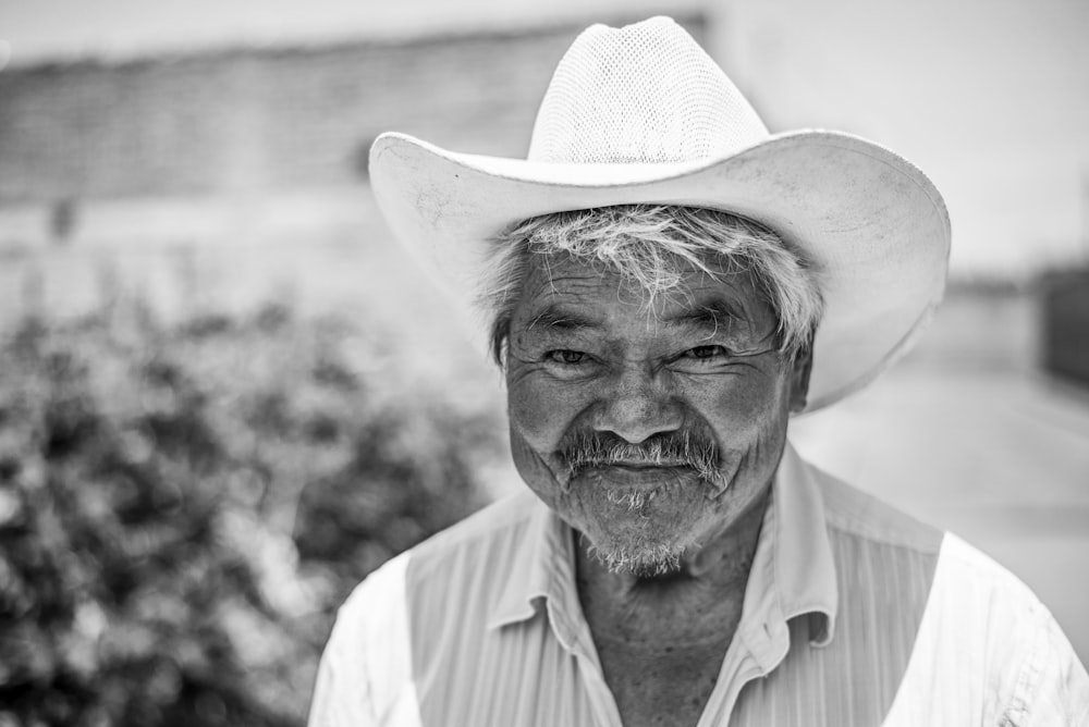 grayscale photo of man wearing cowboy hat