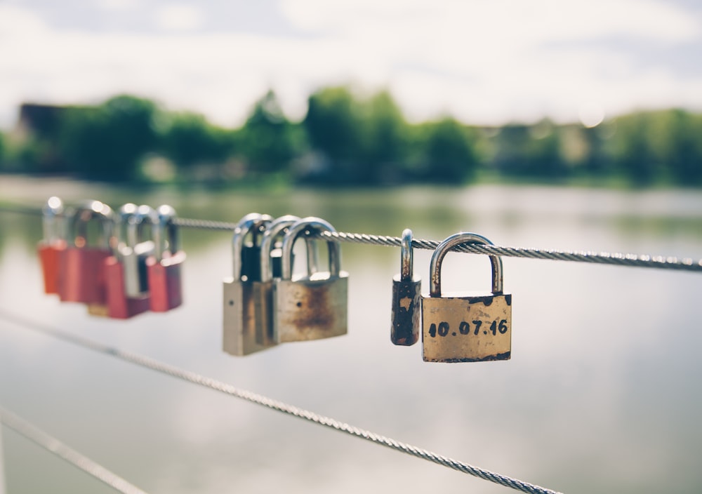 brown and silver padlock on gray metal fence during daytime