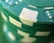 A close-up of colorful casino chips stacked on a green felt table.