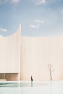 woman standing in front of white building
