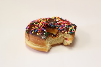 Close-up of a single mochi donut with a bite taken, showing its soft, chewy texture