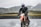 person riding dirt motorcycle on body of water during daytime