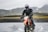 person riding dirt motorcycle on body of water during daytime