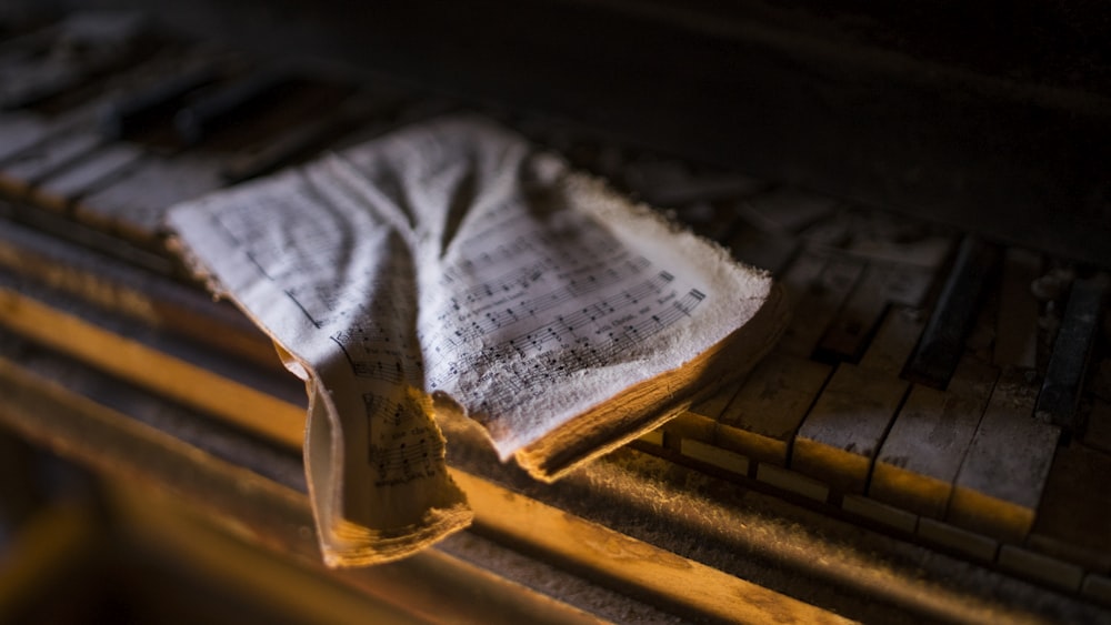 torn music sheet on piano keys