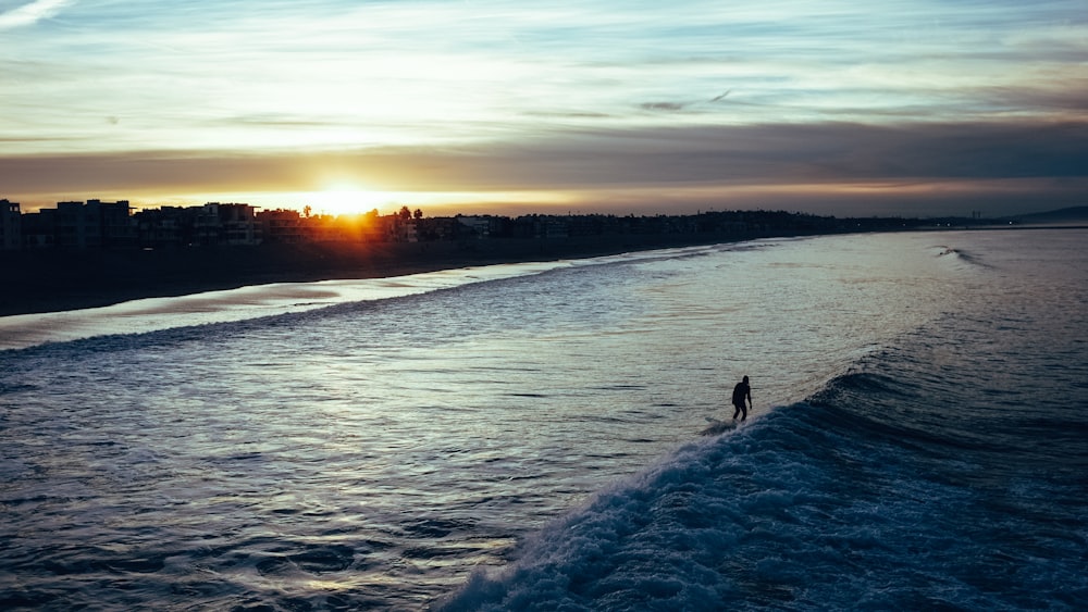 silhouette of person on lake