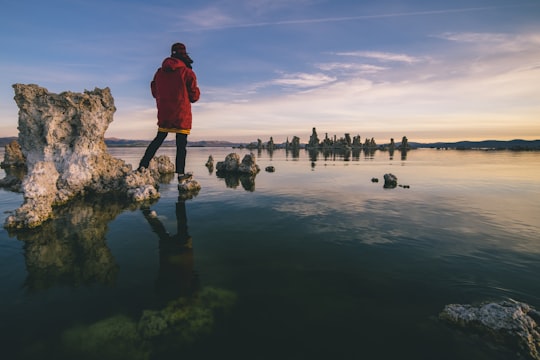 person standing on rocks in Mono Lake United States