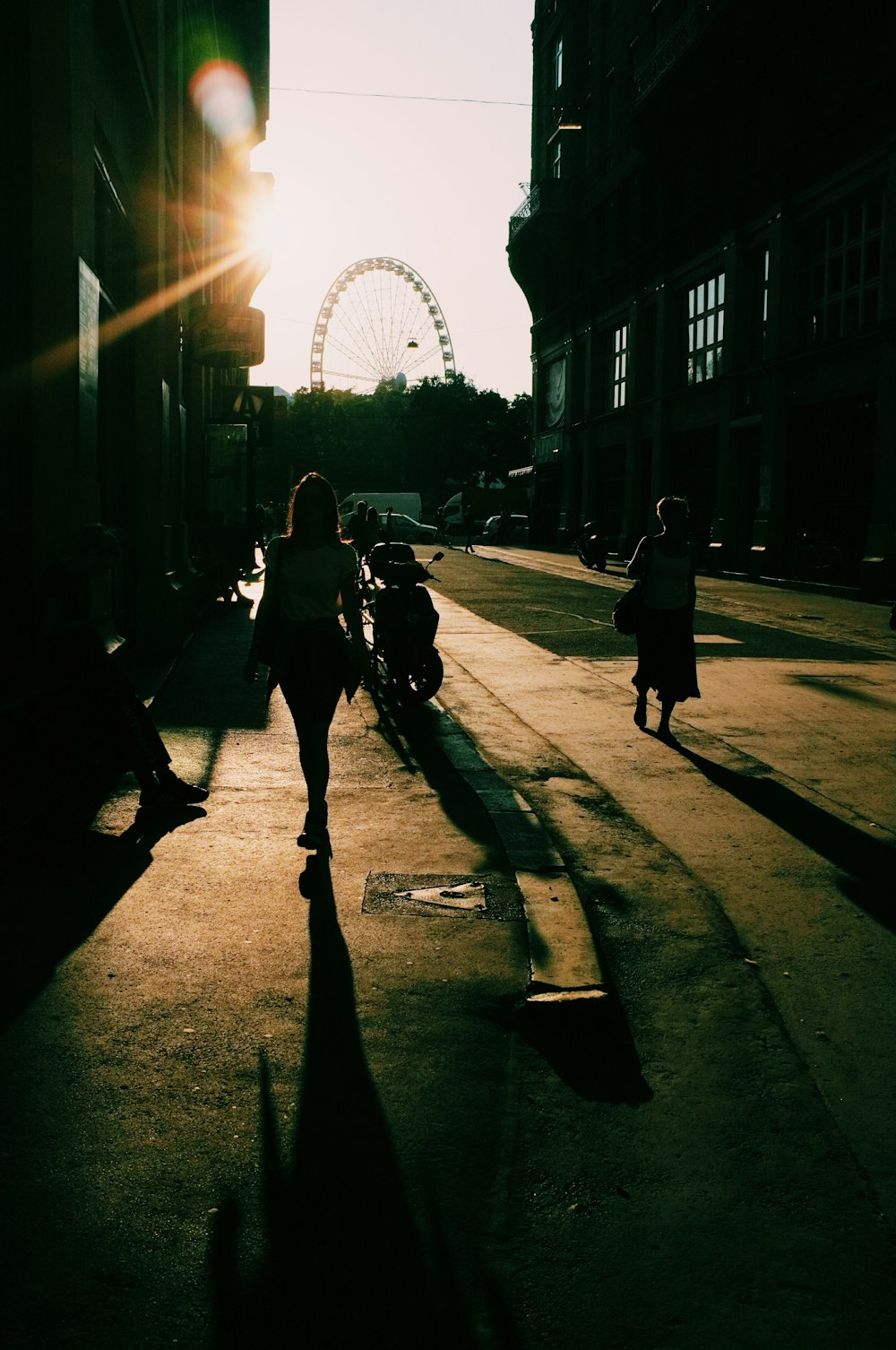 silhouette of people walking near building