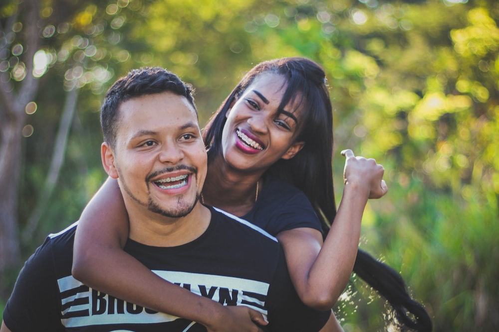 woman on top of man in black shirt