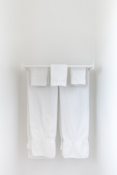Fresh, fluffy towels hanging in a bright, airy bathroom