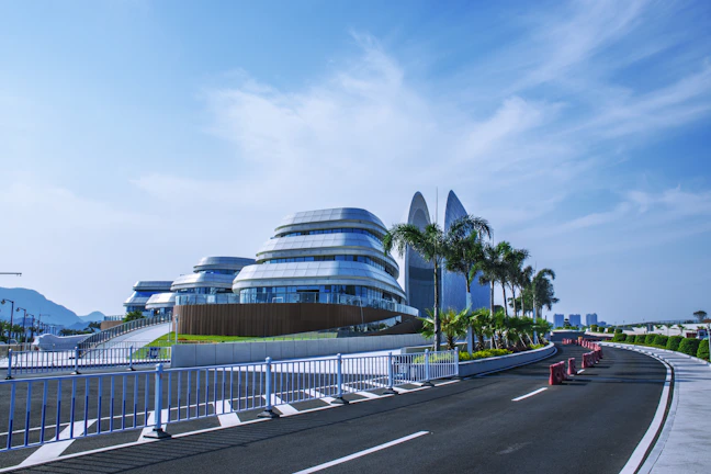 A panoramic shot of a newly completed commercial complex with sleek, modern architecture reflecting the bright Saudi sun.