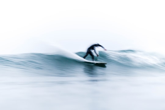 person on surfboard riding waves in Malibu United States