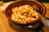 brown ceramic bowl with food