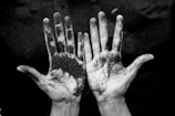 grayscale photo of person's hands